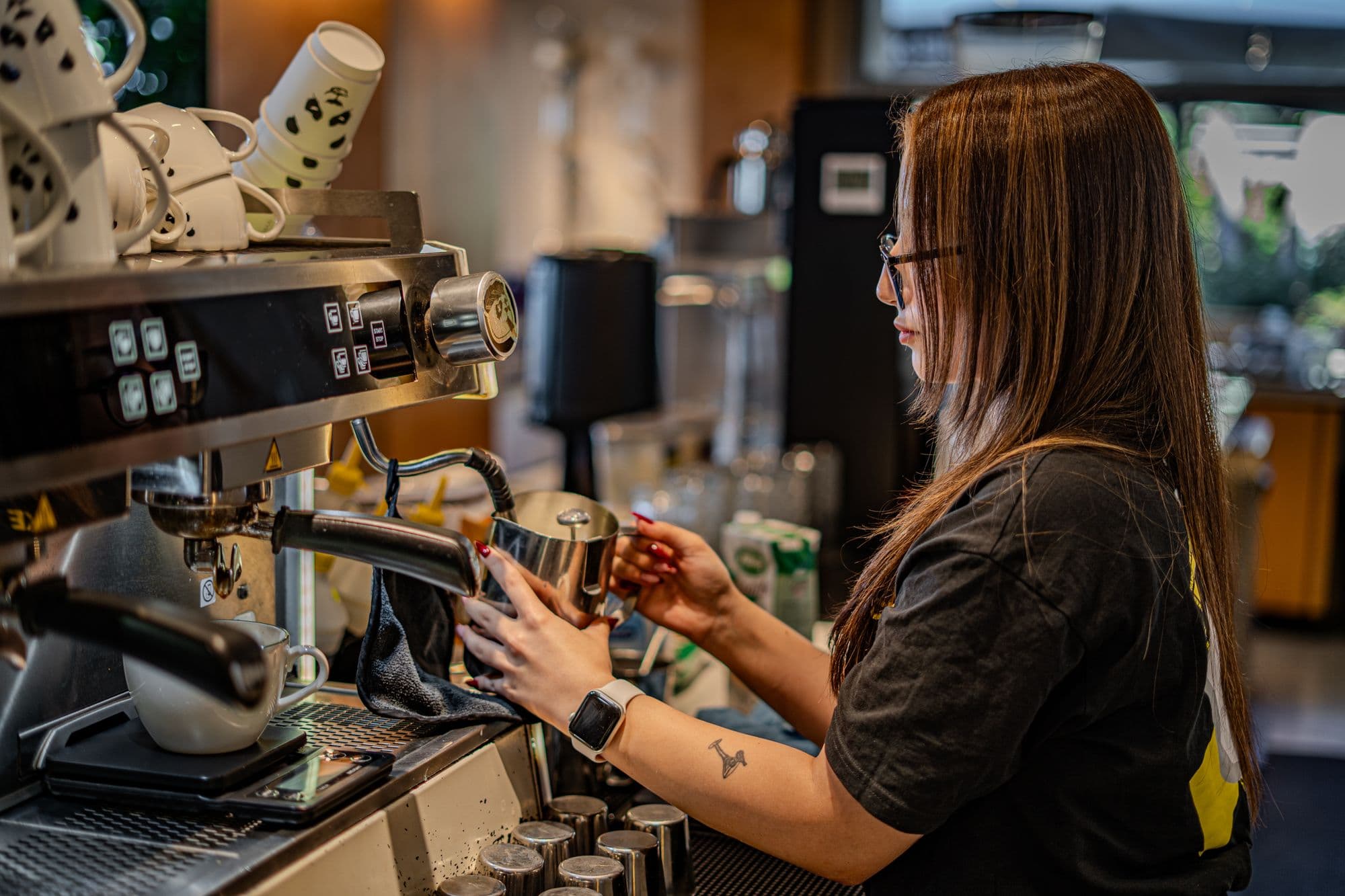 A barista working the espresso machine