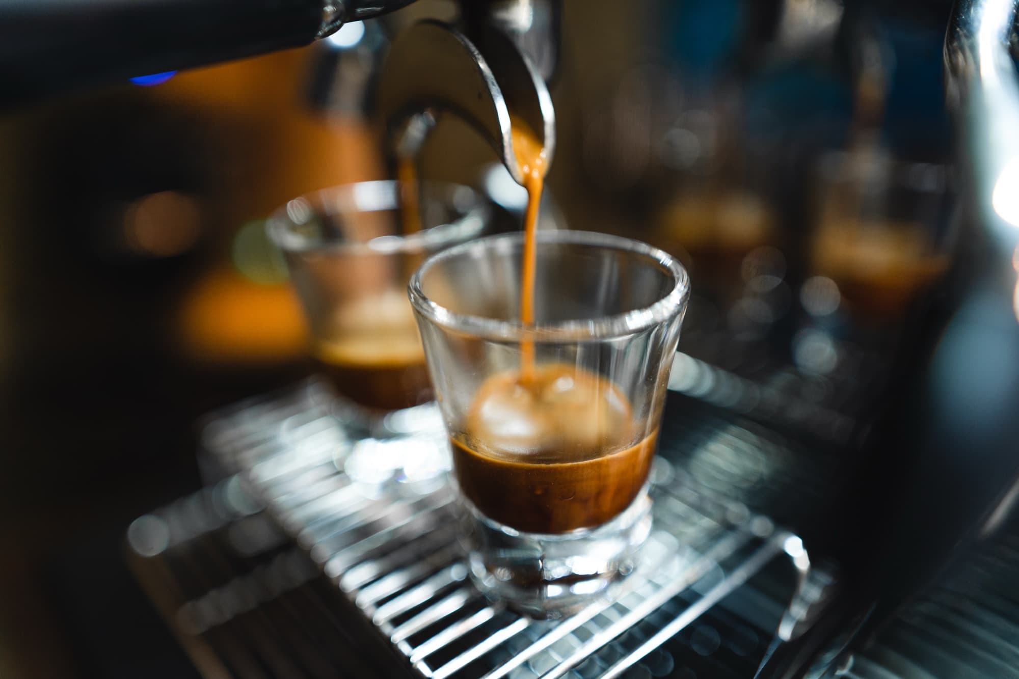 A shot of espresso extracting into a glass